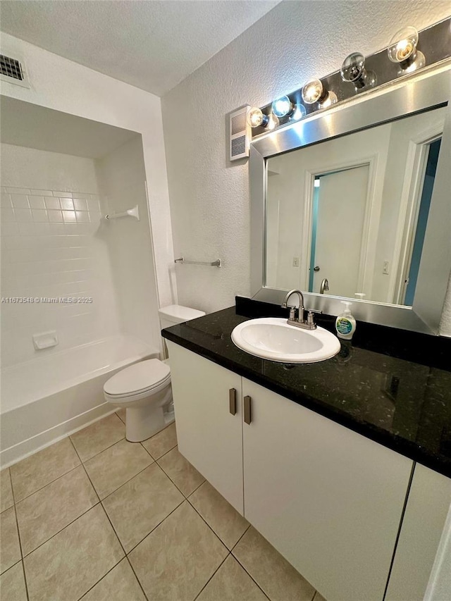 full bathroom with washtub / shower combination, toilet, a textured ceiling, vanity, and tile patterned flooring