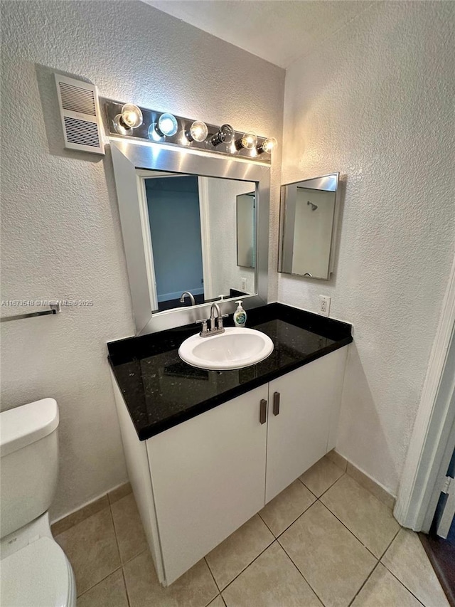 bathroom with tile patterned floors, toilet, and vanity