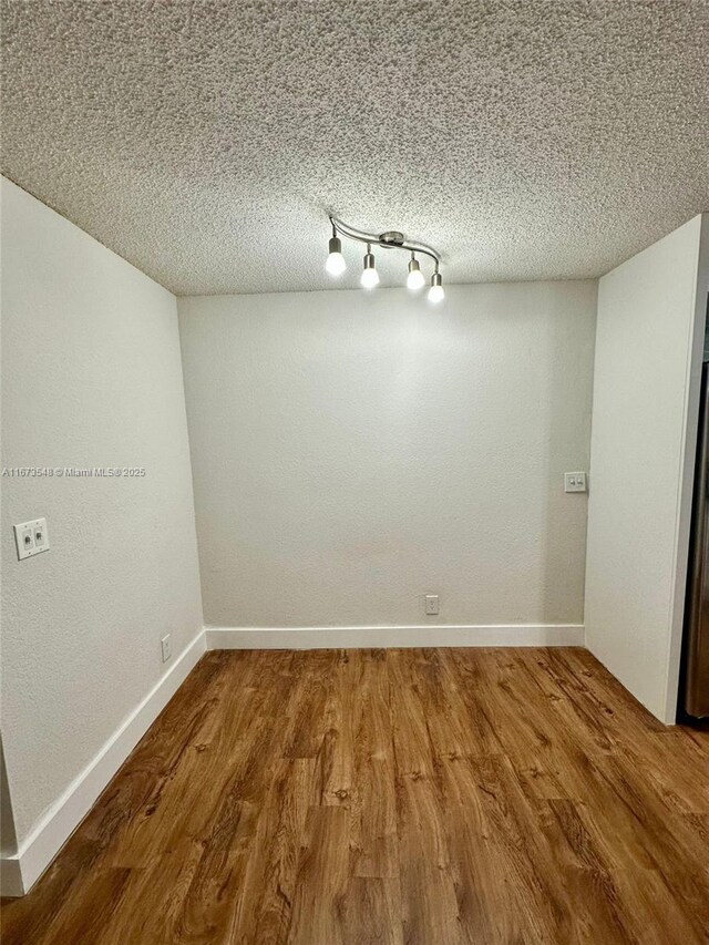 full bathroom featuring toilet, tile patterned flooring, a textured ceiling, vanity, and bathing tub / shower combination