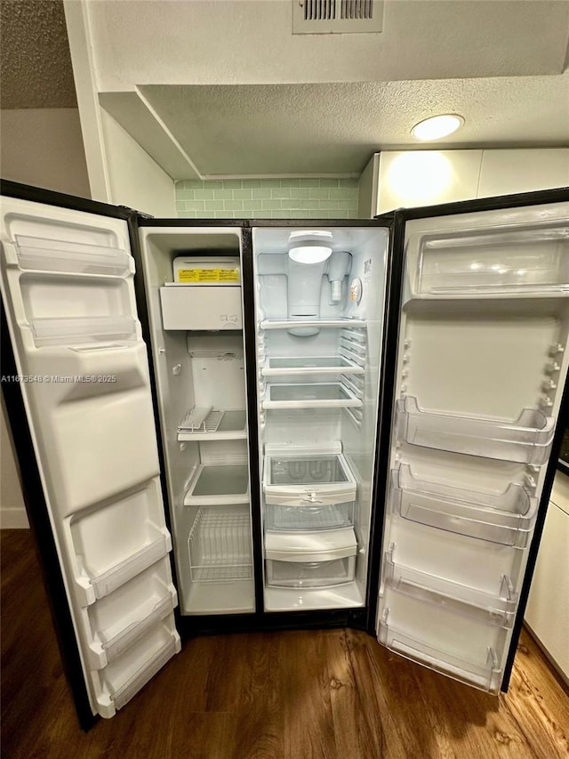 details with fridge and wood-type flooring