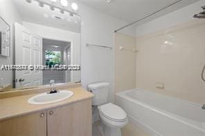 full bathroom featuring bathing tub / shower combination, vanity, and toilet