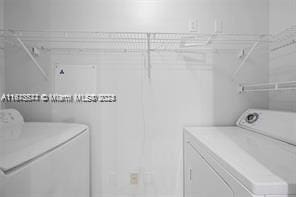 clothes washing area with separate washer and dryer