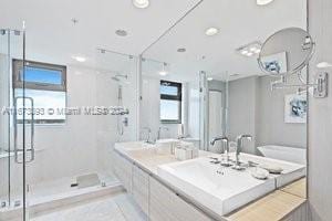 bathroom with vanity and a shower with shower door