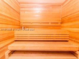 view of sauna featuring wooden walls