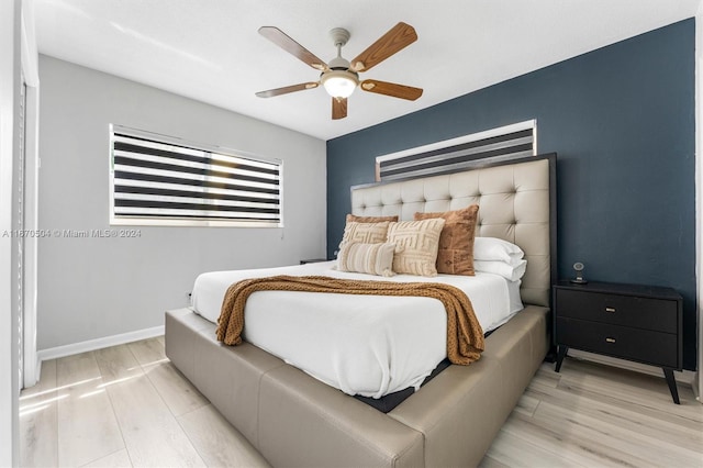 bedroom featuring light hardwood / wood-style flooring and ceiling fan