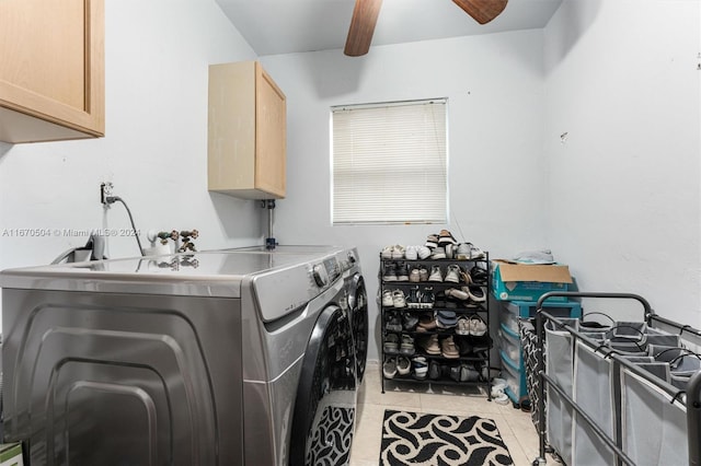 clothes washing area featuring washer and dryer, ceiling fan, light tile patterned floors, and cabinets