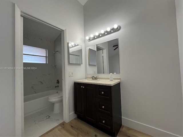 full bathroom with wood-type flooring, vanity, toilet, and tiled shower / bath