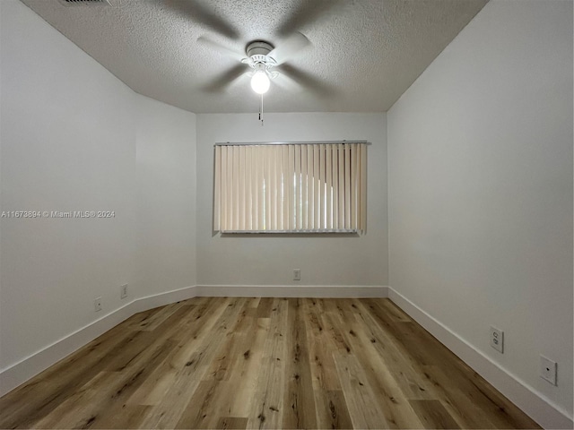 unfurnished room featuring ceiling fan, a textured ceiling, and light hardwood / wood-style flooring