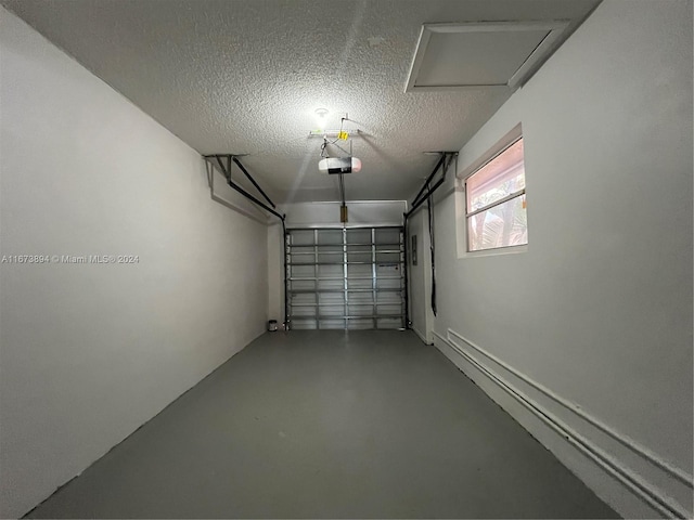 garage with a garage door opener and a baseboard radiator