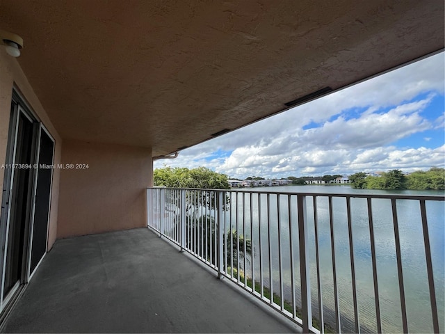 balcony featuring a water view