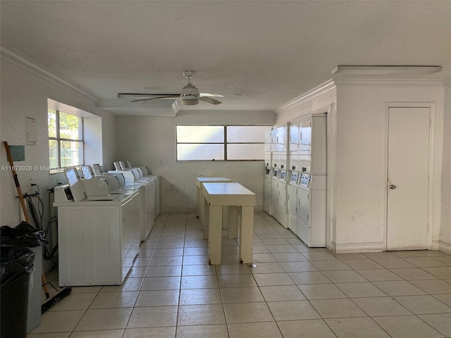 shared laundry area with a ceiling fan, light tile patterned flooring, crown molding, and washing machine and clothes dryer