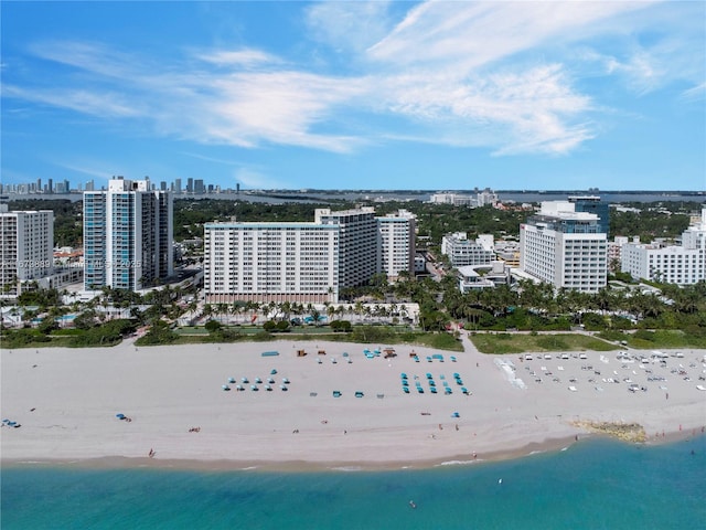 aerial view with a water view, a beach view, and a city view