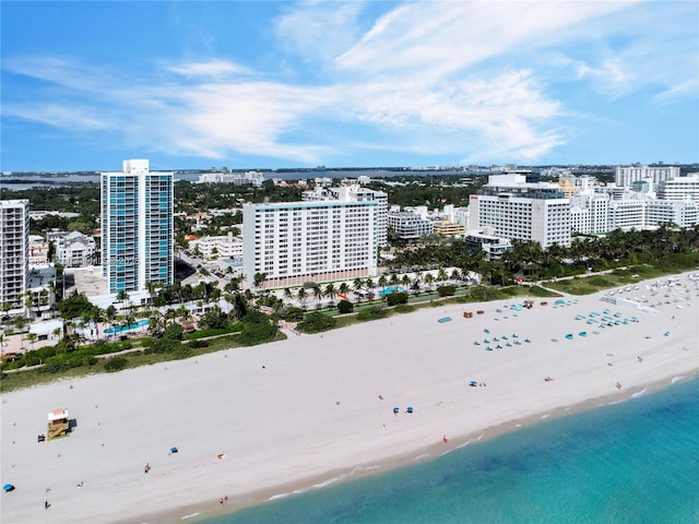 aerial view with a city view, a view of the beach, and a water view