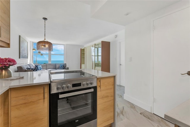 kitchen featuring open floor plan, stainless steel electric range, marble finish floor, and light countertops