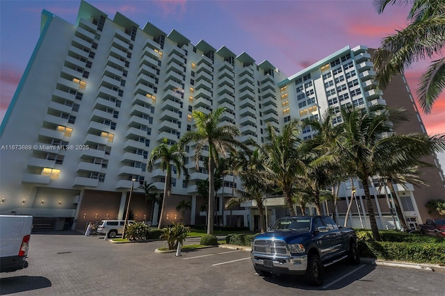 property at dusk featuring uncovered parking