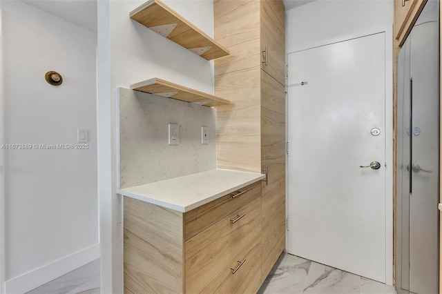 kitchen featuring tasteful backsplash, modern cabinets, marble finish floor, and open shelves