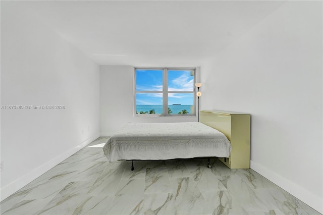 bedroom featuring baseboards and marble finish floor