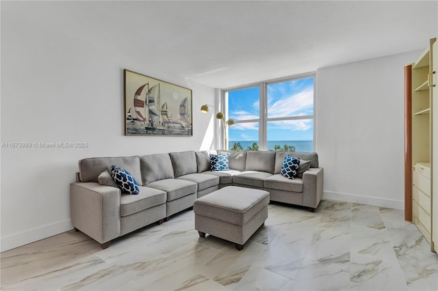 living room with expansive windows, marble finish floor, and baseboards