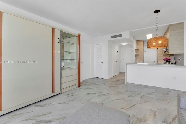kitchen with visible vents, marble finish floor, and decorative light fixtures