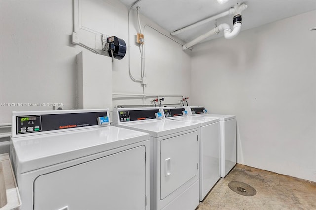 clothes washing area with separate washer and dryer