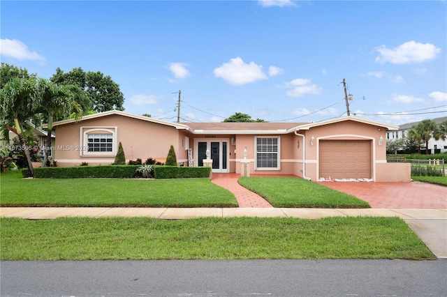 single story home with a front yard and a garage