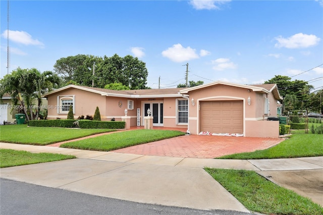 single story home with a garage and a front lawn