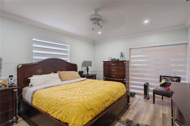 bedroom featuring crown molding, light hardwood / wood-style flooring, and ceiling fan