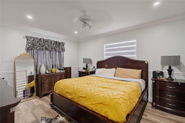 bedroom with light wood-type flooring, crown molding, and ceiling fan