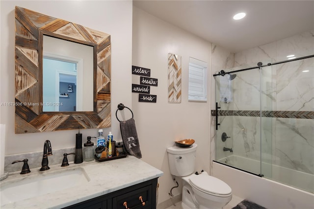 full bathroom with vanity, toilet, and combined bath / shower with glass door