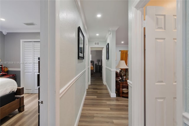 corridor featuring hardwood / wood-style floors and ornamental molding