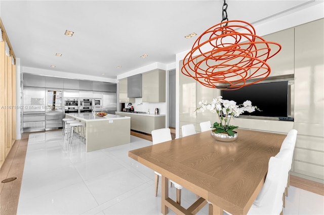800 S Pointe Dr Unit 901, Miami Beach, FL 33139 - dining area with a chandelier and light tile patterned flooring