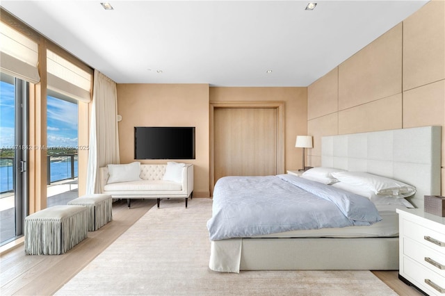 bedroom featuring light hardwood / wood-style flooring and access to outside