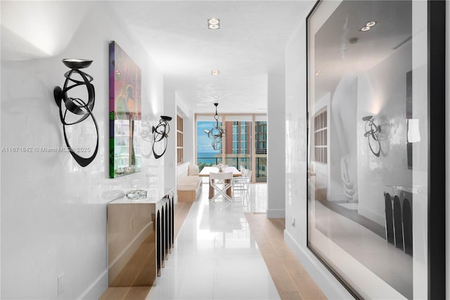 800 S Pointe Dr Unit 901, Miami Beach, FL 33139 - hall featuring a chandelier, baseboards, and light tile patterned floors