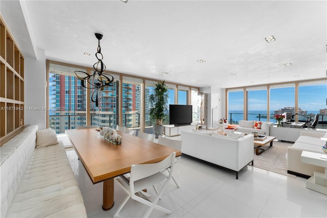 tiled dining room featuring expansive windows and a chandelier