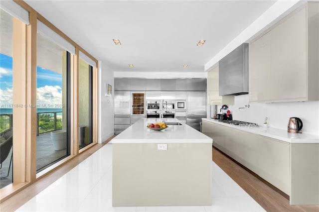 800 S Pointe Dr Unit 901, Miami Beach, FL 33139 - kitchen featuring modern cabinets, light countertops, a kitchen island with sink, and stainless steel gas stovetop