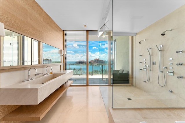 bathroom featuring tiled shower, a water view, a healthy amount of sunlight, and wooden walls