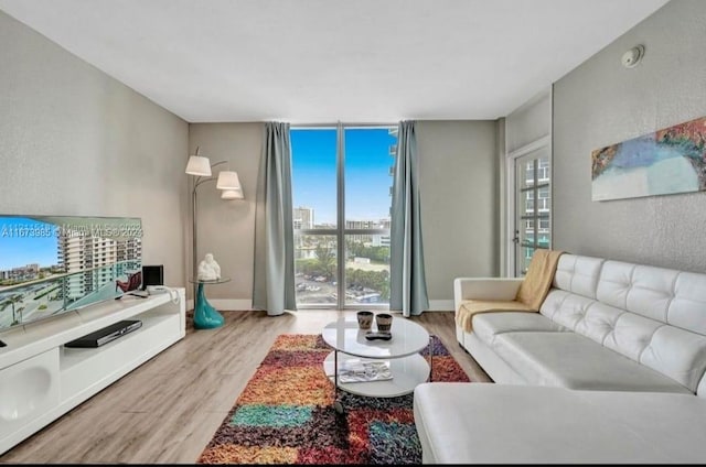 3801 S Ocean Dr Unit 9W, Hollywood, FL 33019 - living area featuring a wall of windows, a city view, and wood finished floors