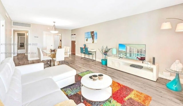 3801 S Ocean Dr Unit 9W, Hollywood, FL 33019 - living room featuring baseboards, wood finished floors, and visible vents