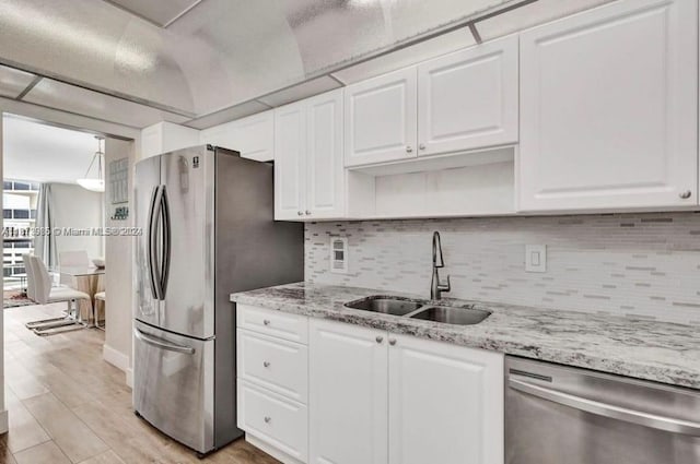 3801 S Ocean Dr Unit 9W, Hollywood, FL 33019 - kitchen with backsplash, white cabinetry, appliances with stainless steel finishes, and a sink
