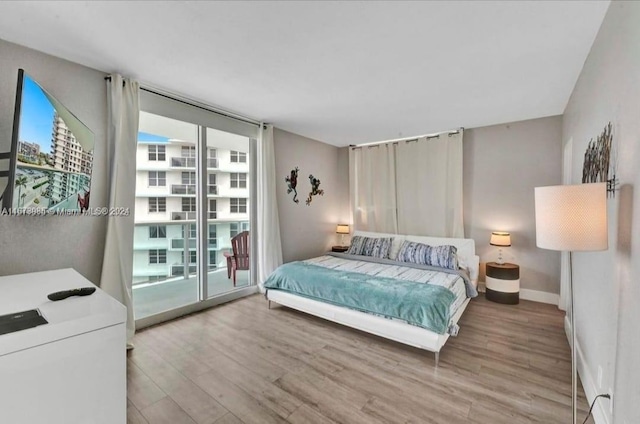 3801 S Ocean Dr Unit 9W, Hollywood, FL 33019 - bedroom featuring baseboards, wood finished floors, and access to exterior