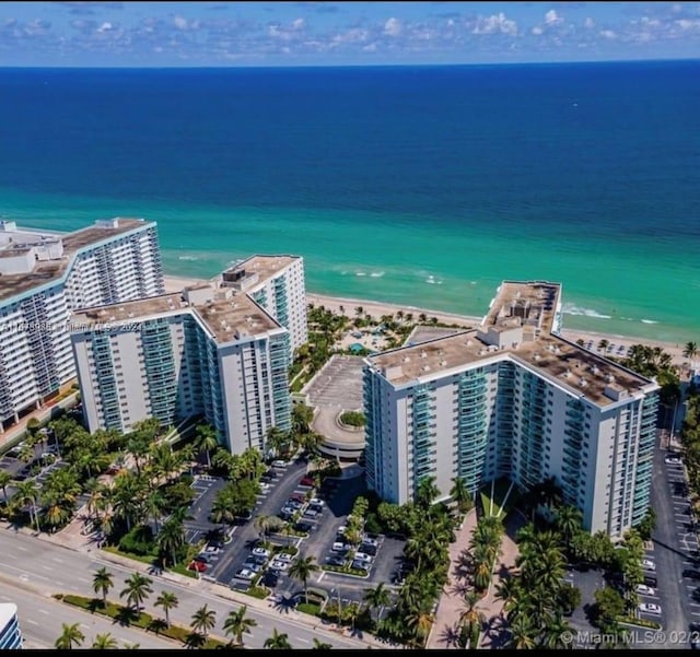 bird's eye view featuring a water view and a beach view