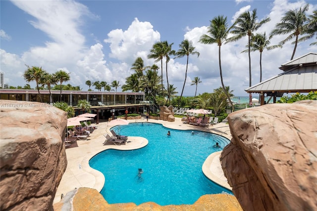 view of swimming pool featuring a gazebo, a water view, and a patio