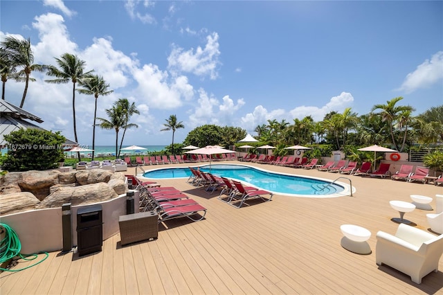 view of swimming pool featuring a water view and a patio area