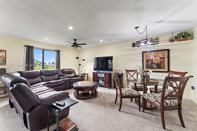 carpeted living room with a textured ceiling and ceiling fan