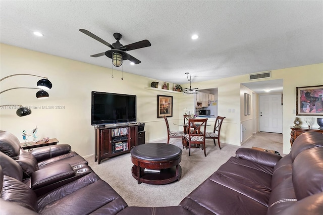 living room with light carpet, a textured ceiling, and ceiling fan