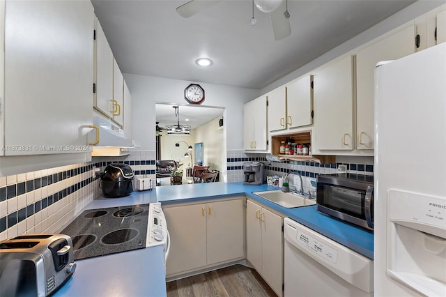 kitchen featuring decorative backsplash, white cabinetry, white appliances, and dark hardwood / wood-style flooring