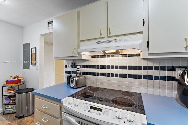 kitchen featuring electric panel, decorative backsplash, white stove, and light hardwood / wood-style floors