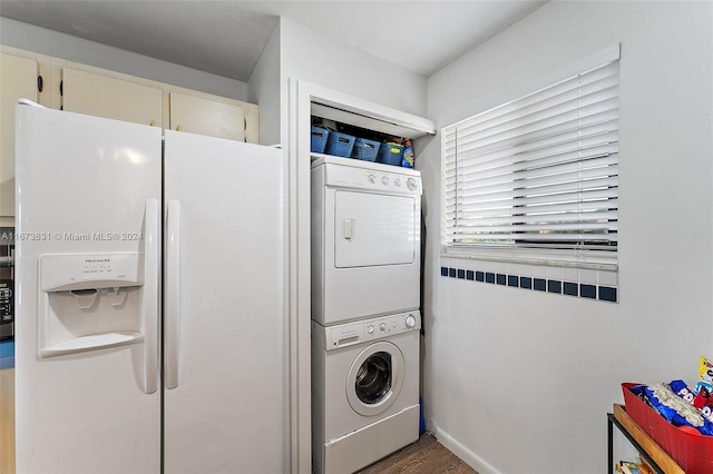 washroom with dark hardwood / wood-style flooring and stacked washer and clothes dryer