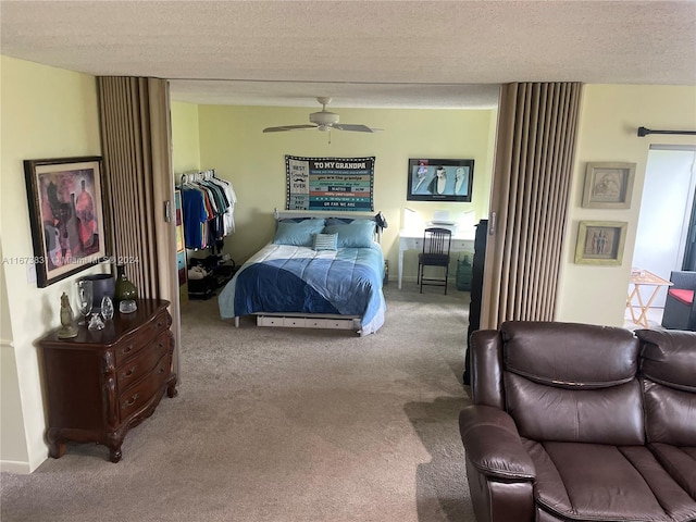 bedroom featuring ceiling fan, carpet flooring, and a textured ceiling