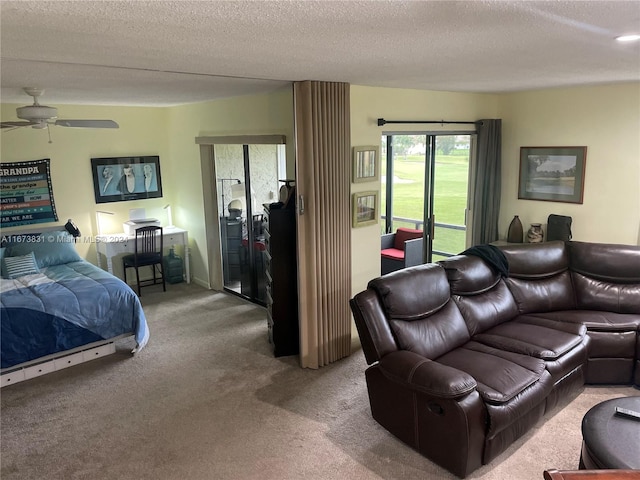 interior space with a textured ceiling, access to exterior, and ceiling fan